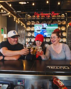 People cheering drinks at the 12th Street Tavern bar